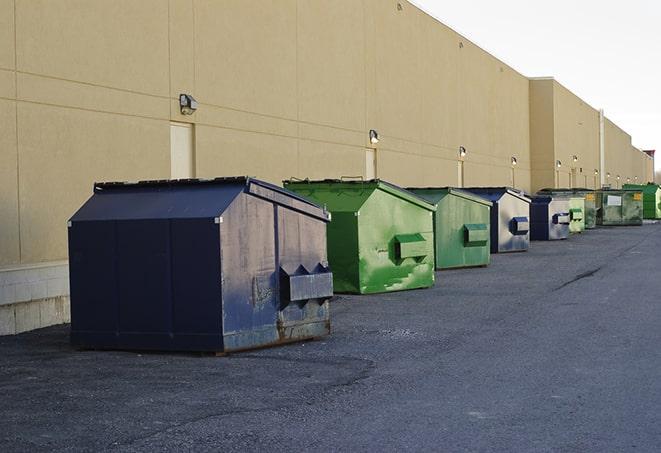 a yellow construction dumpster filled with waste materials in Bronxville, NY